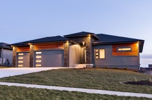 A stone and wooden exterior of a home built by Kruse Development.
